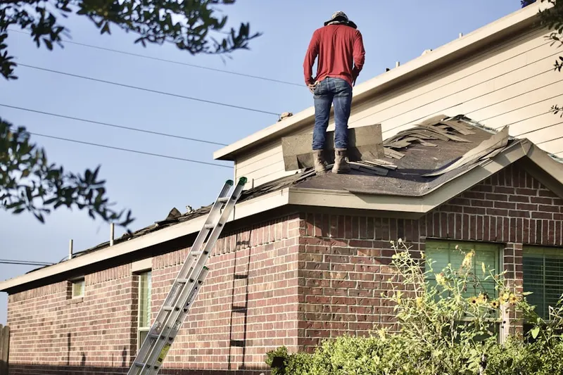 Professional roofer working on a residential roof in Pocahontas